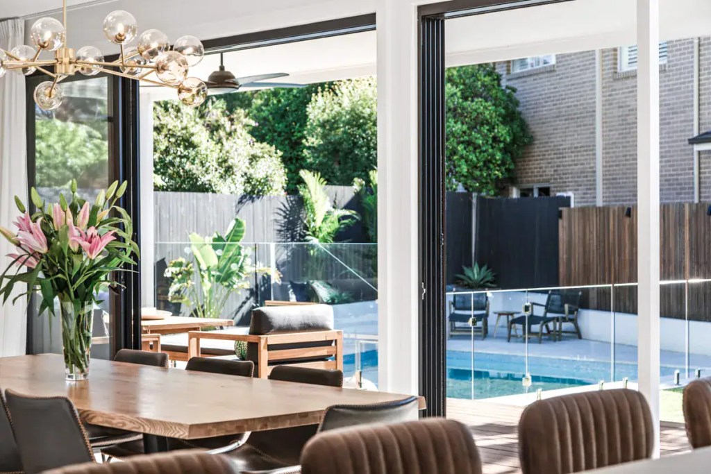 Surface-mounted frameless glass pool fence with polished stainless-steel hardware finish, installed in an Allambie Heights home.
