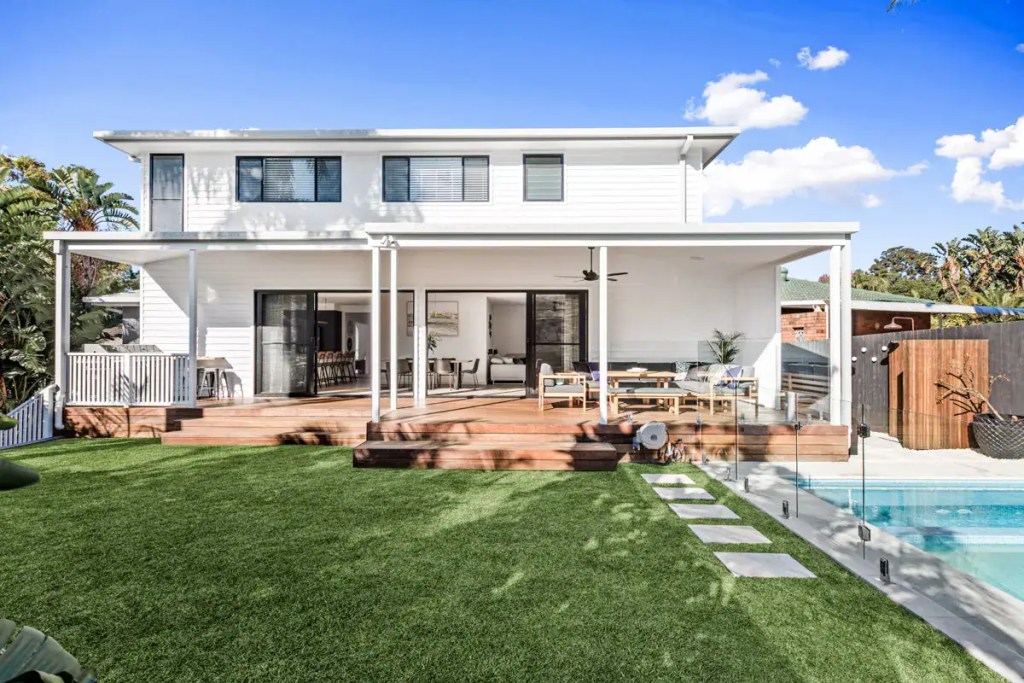 Surface-mounted frameless glass pool fence with polished stainless-steel hardware finish, installed in a Allambie Heights home.