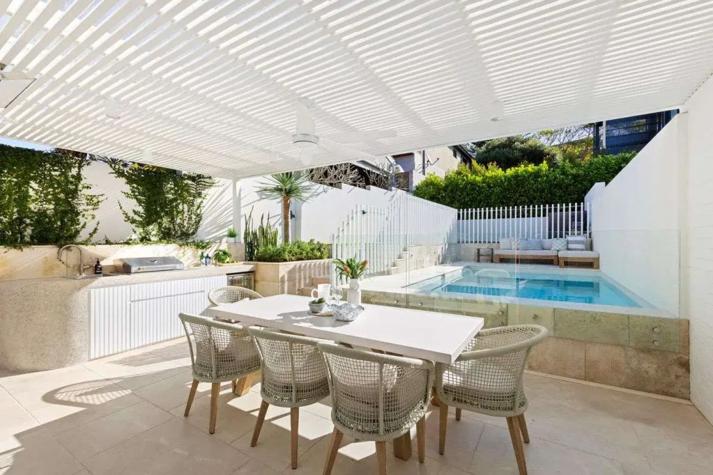 Side-fixed frameless glass pool fence with standoff brackets in polished stainless-steel hardware finish, installed in a Balgowlah home.