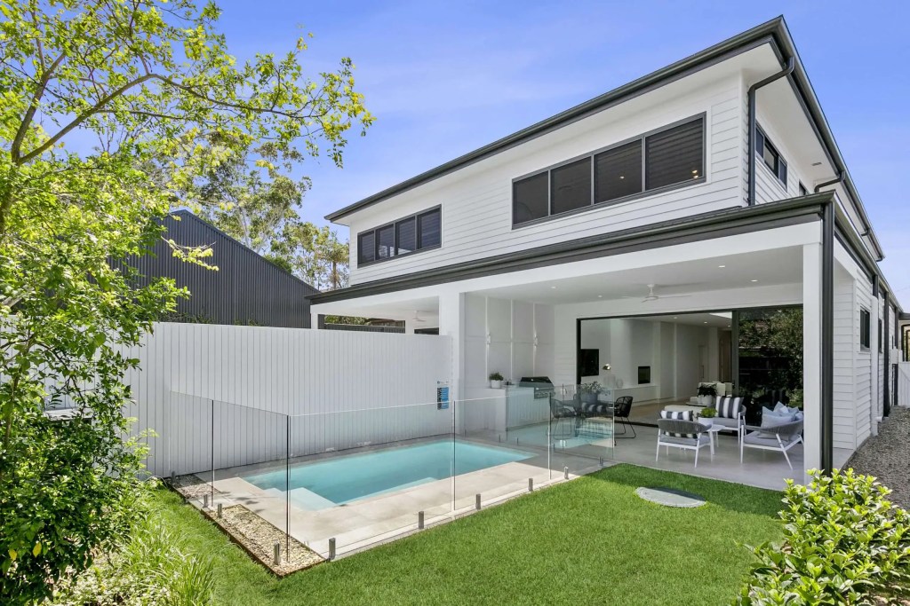 Surface-mounted frameless glass pool fence with satin-stainless steel hardware finish, installed in a Balgowlah heights home.