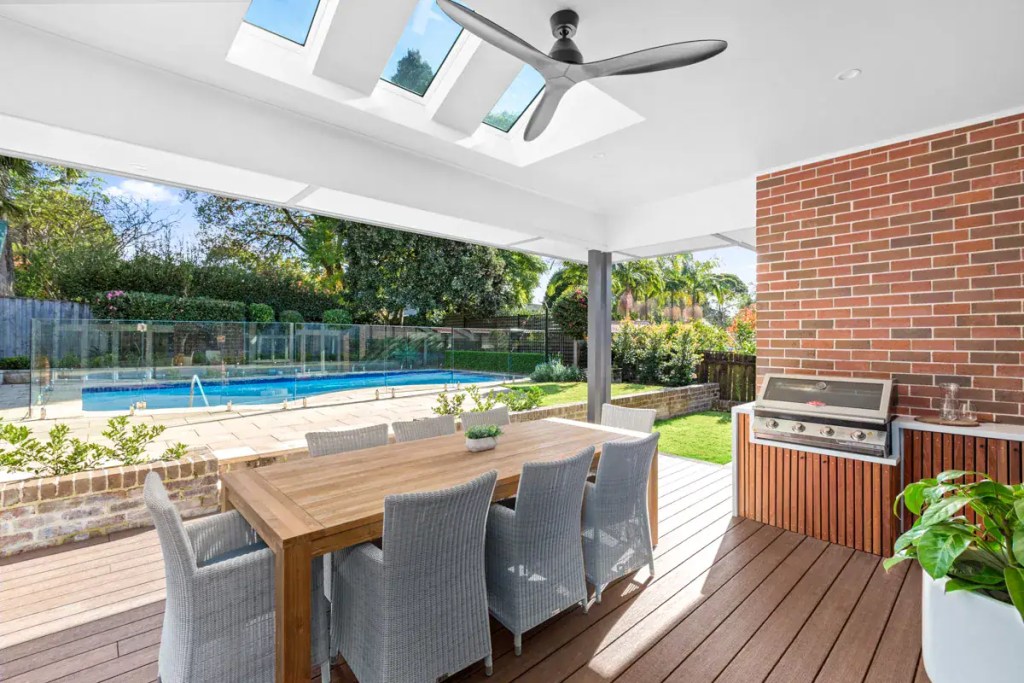 Surface-mounted frameless glass pool fence with polished stainless-steel hardware finish, installed in a Turramurra home.